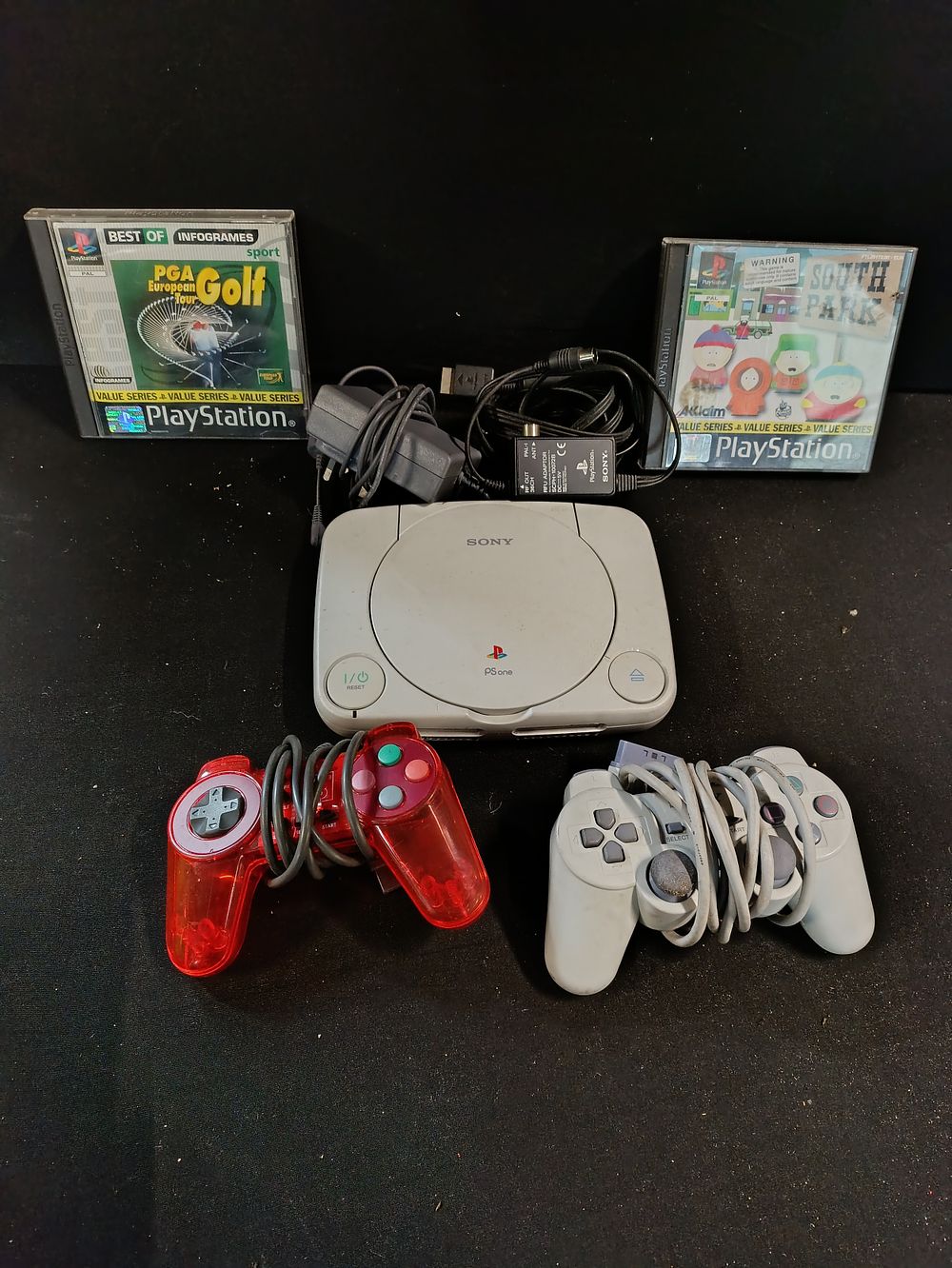 Lot 449: Sony Playstation One Slim with wires, controllers and...