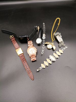 Mixed lot of watches to include a pocket watch, Michael Kors, Timex, Guess and more.