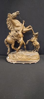 Spelter statue of 2 horses and a handler on a wooden base