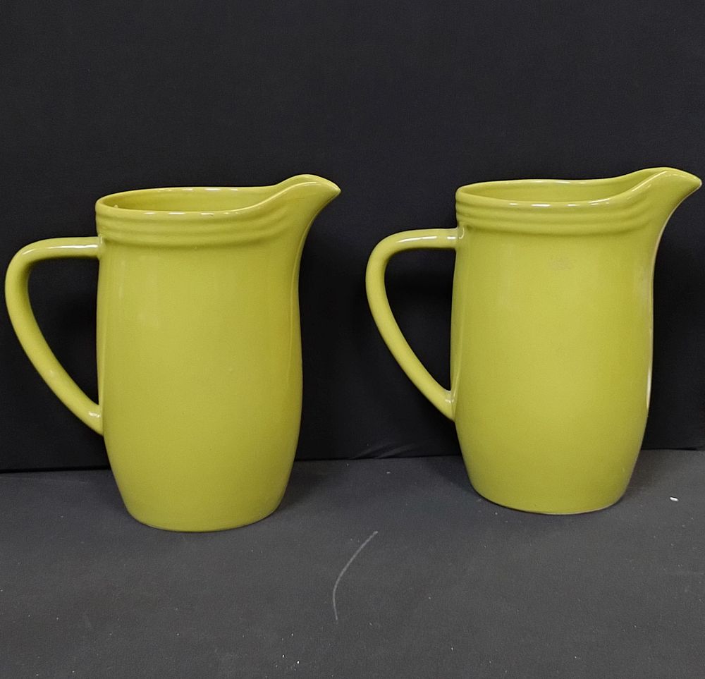 Lot 173: Two tall green Trends jugs. Measures approx H...