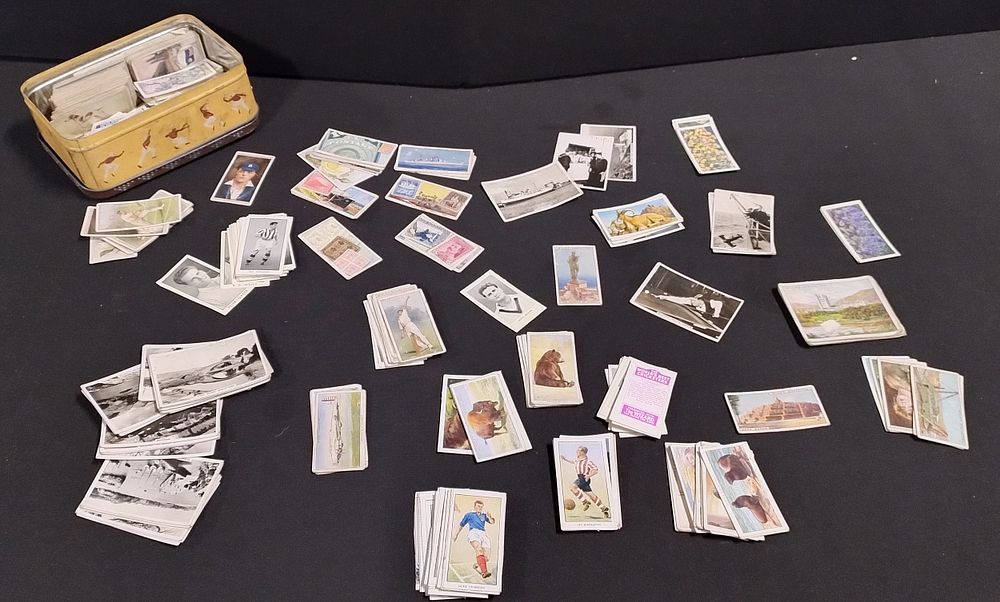 Lot 319: tin containing vintage cigarette cards covering various subjects