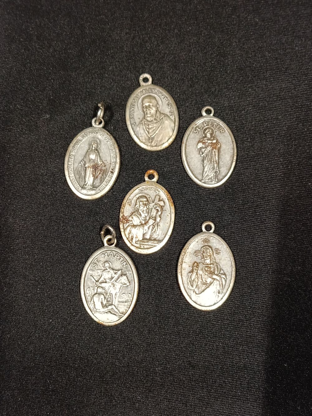 Lot 330: Five religious pendants including Saint Andrew, Saint Peter...