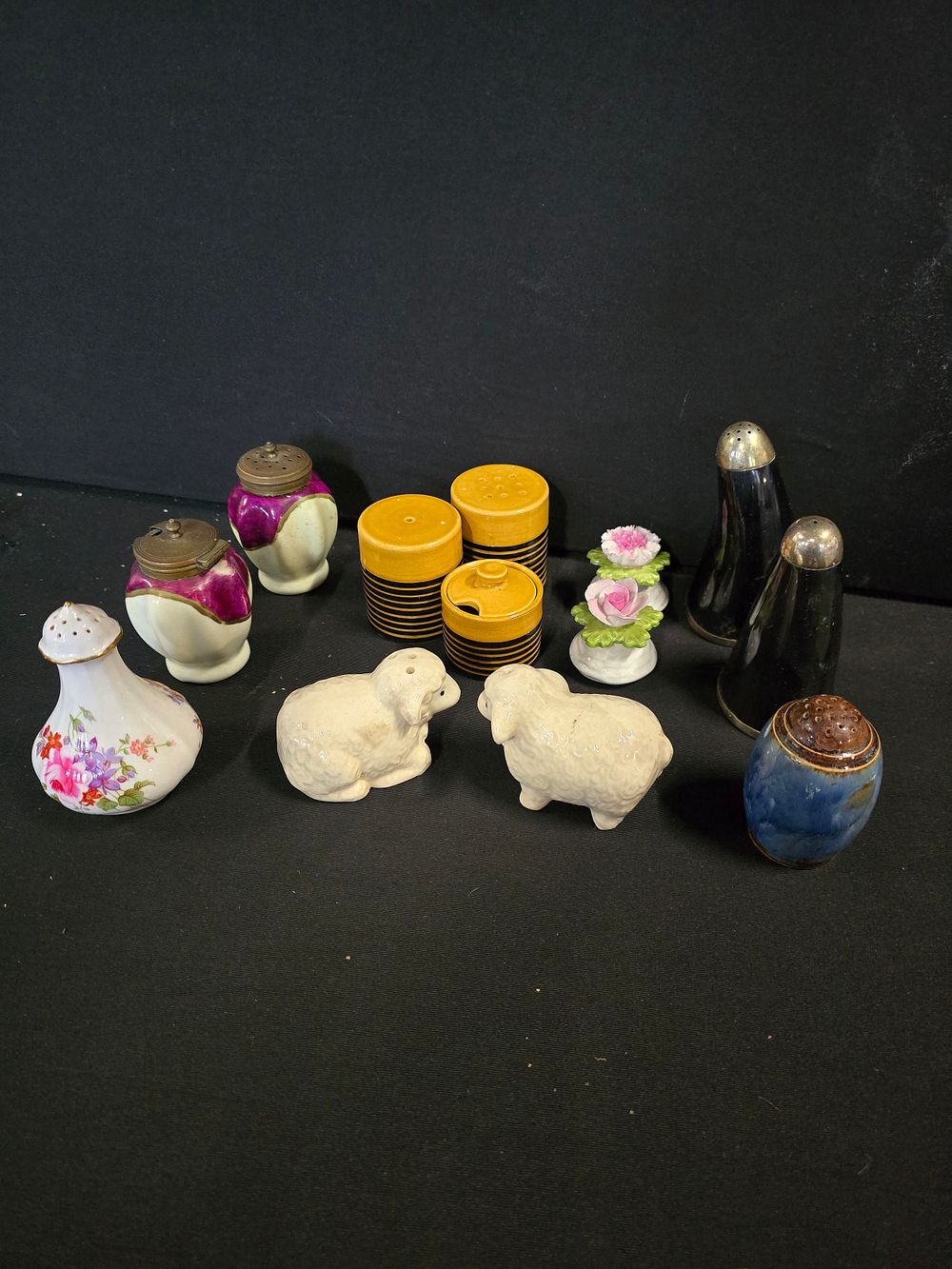 Lot 384: A collection of salt and pepper pots, sugar...