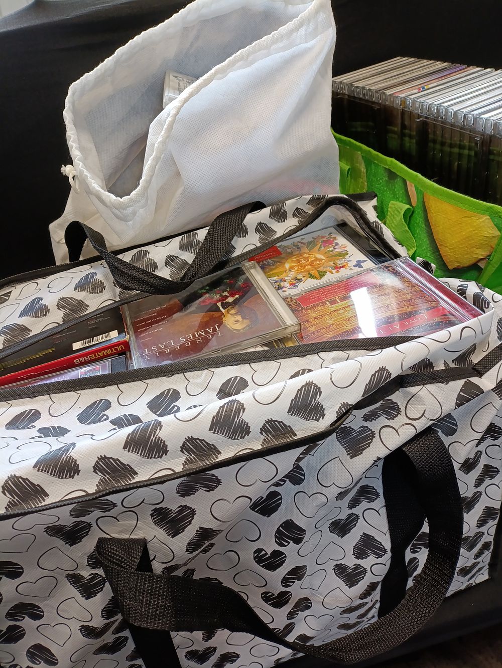 Lot 396: Three large bags of DVDs and CDs, mixed...