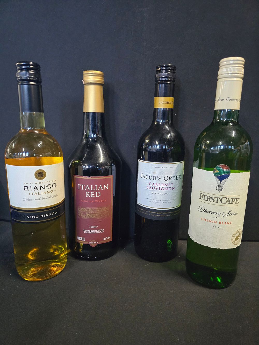 Lot 422: Four sealed bottles of red and white wine....