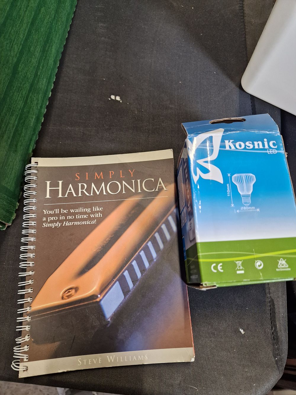 Lot 245: Harmonica book and Kosnic LED bulb