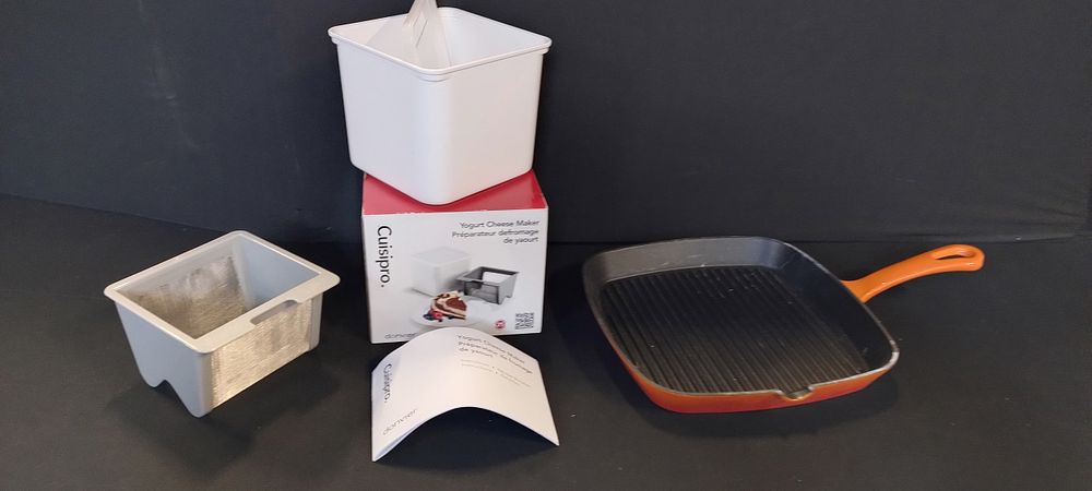 Lot 235: Orange skillet pan and a boxed Cuisipro yogurt...