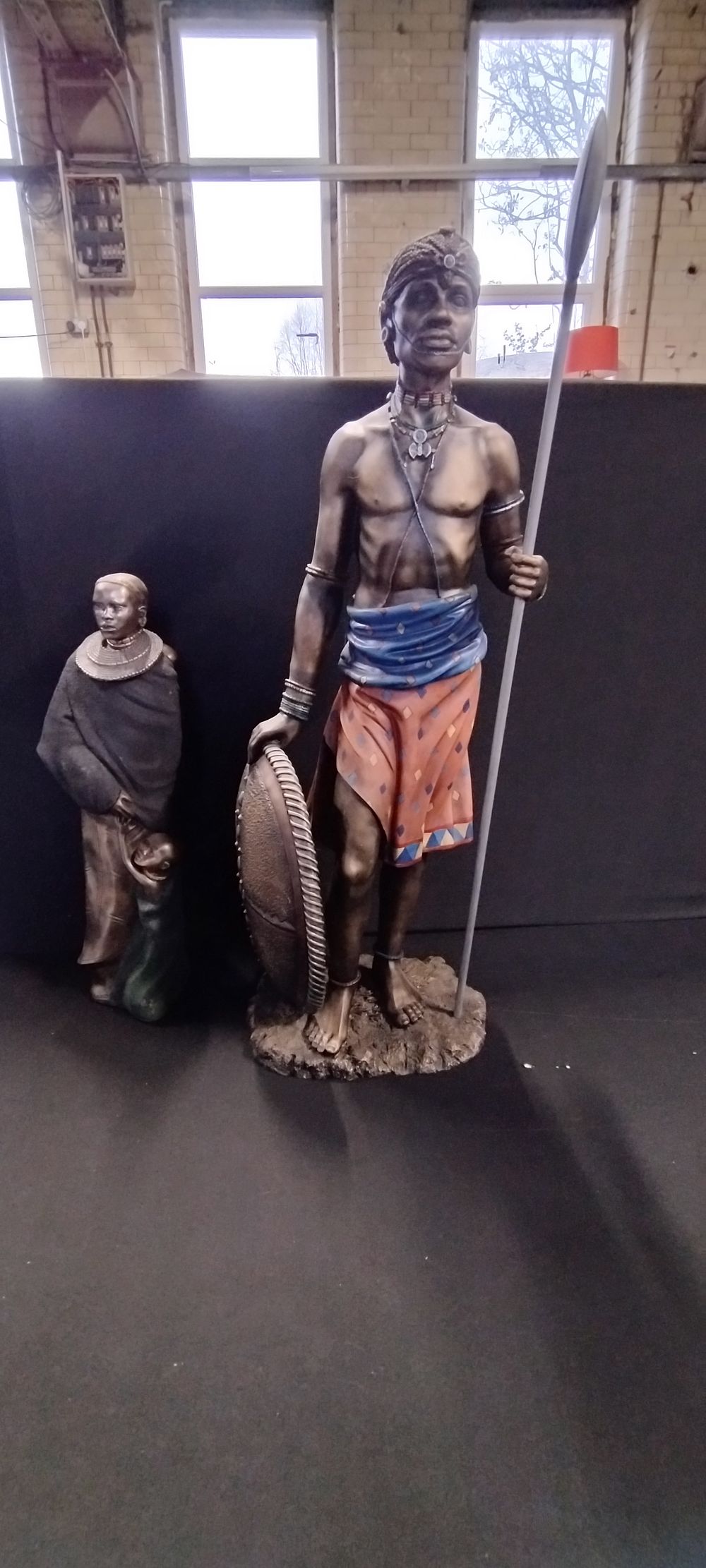 Lot 249: Two Masai figurines one Leonardo collection 2003