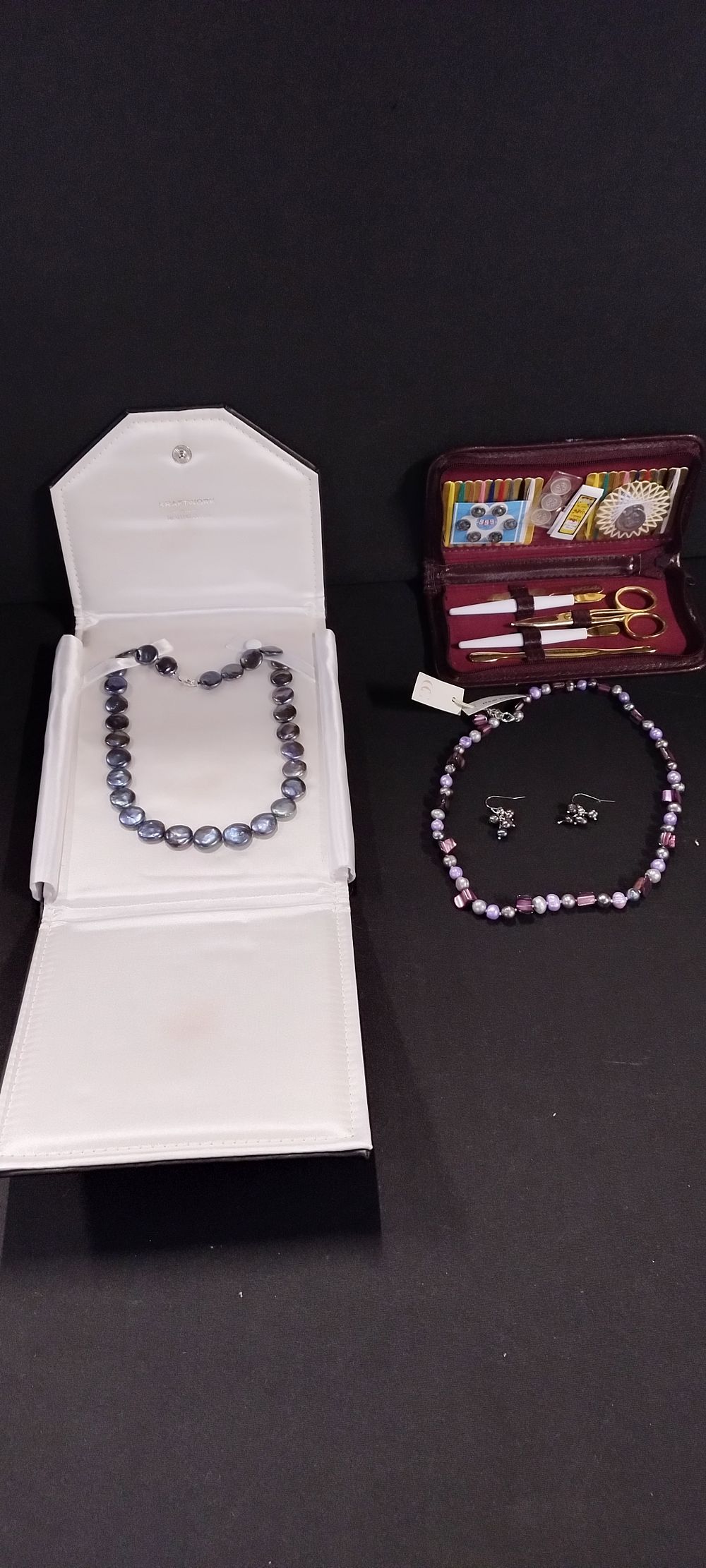Lot 251: Two pearl necklaces and a pair of earrings,...