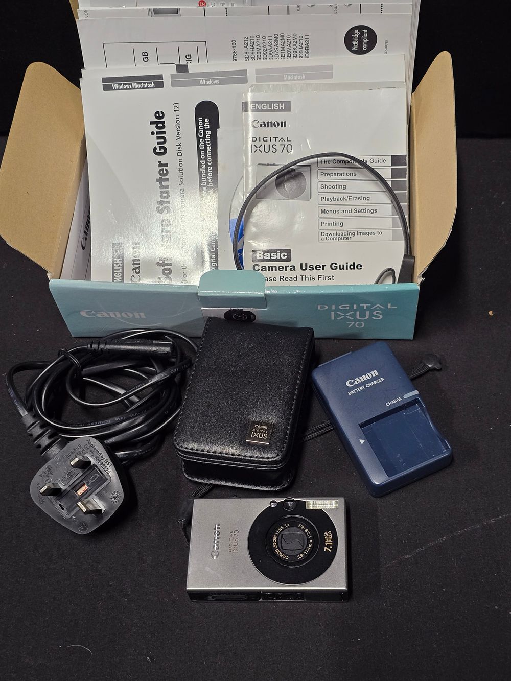 Lot 319: CANON IXUS digital camera. With original case, charger,...