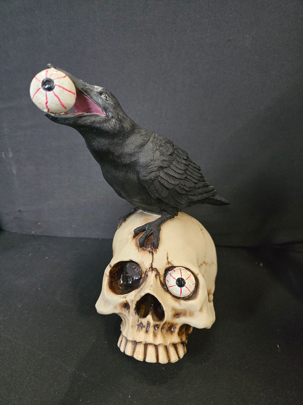 Lot 443: Bird with skull ornament.