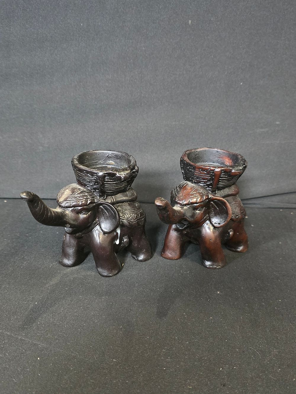 Lot 451: A pair of ebony wooden elephant candle holders