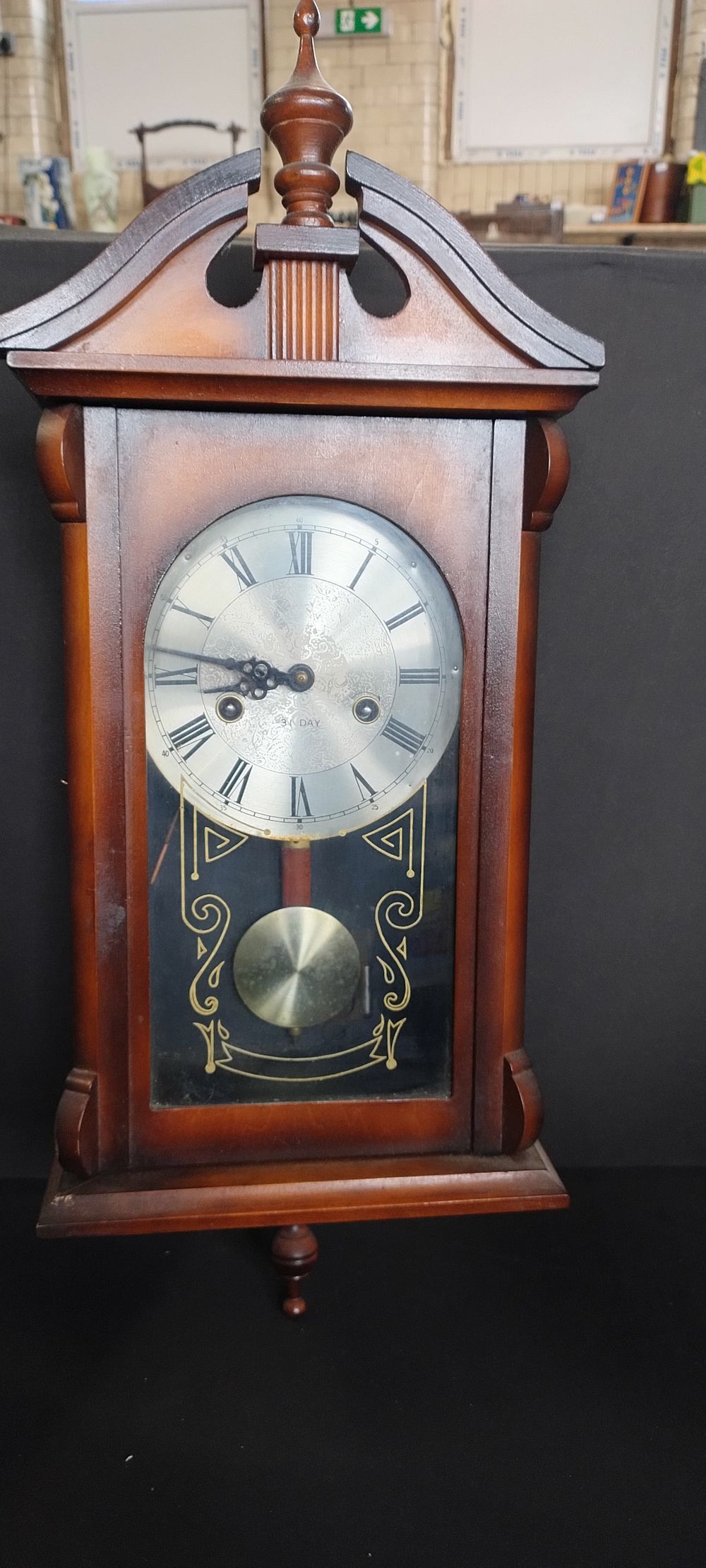 Lot 178: 31 day wall hanging pendulum wooden clock, etched...
