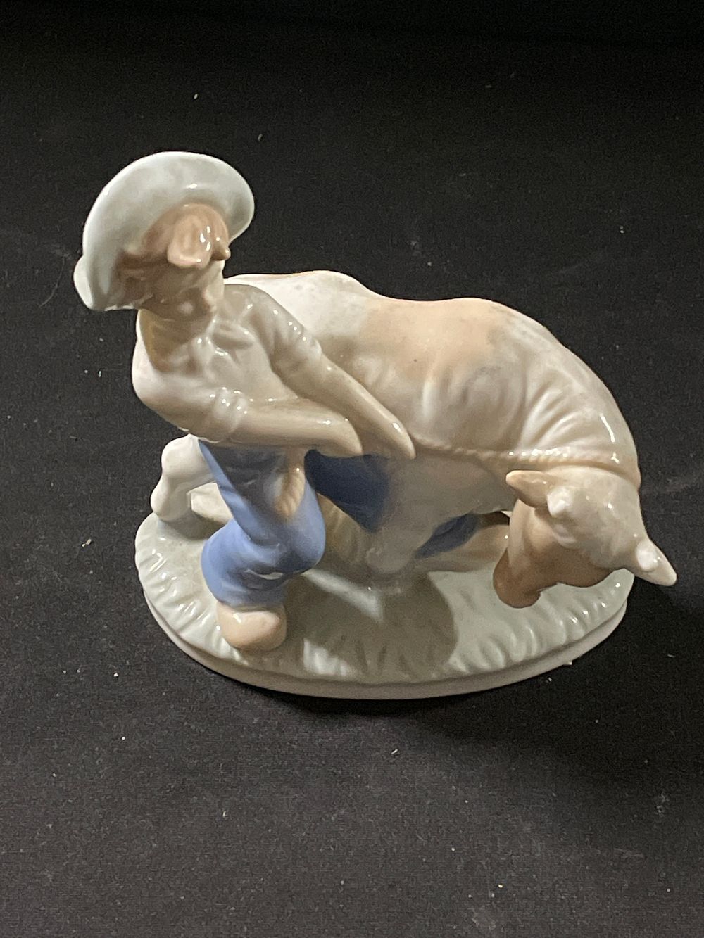 Lot 241: Porcelain figurine of a boy and cow
