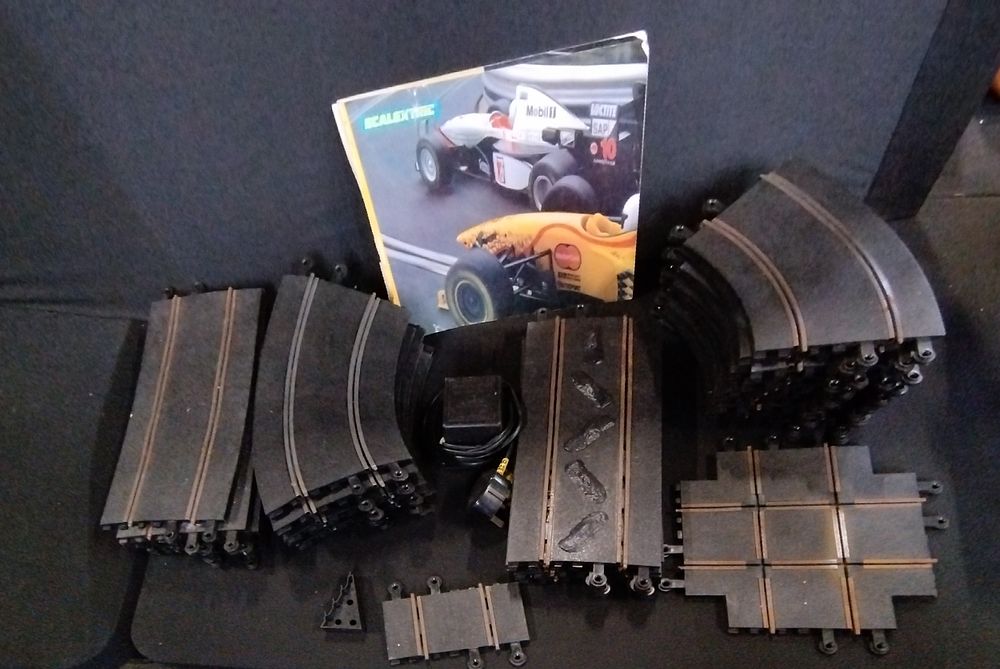 Lot 310: Vintage Scalextric track ,power unit and Scalextric booklet