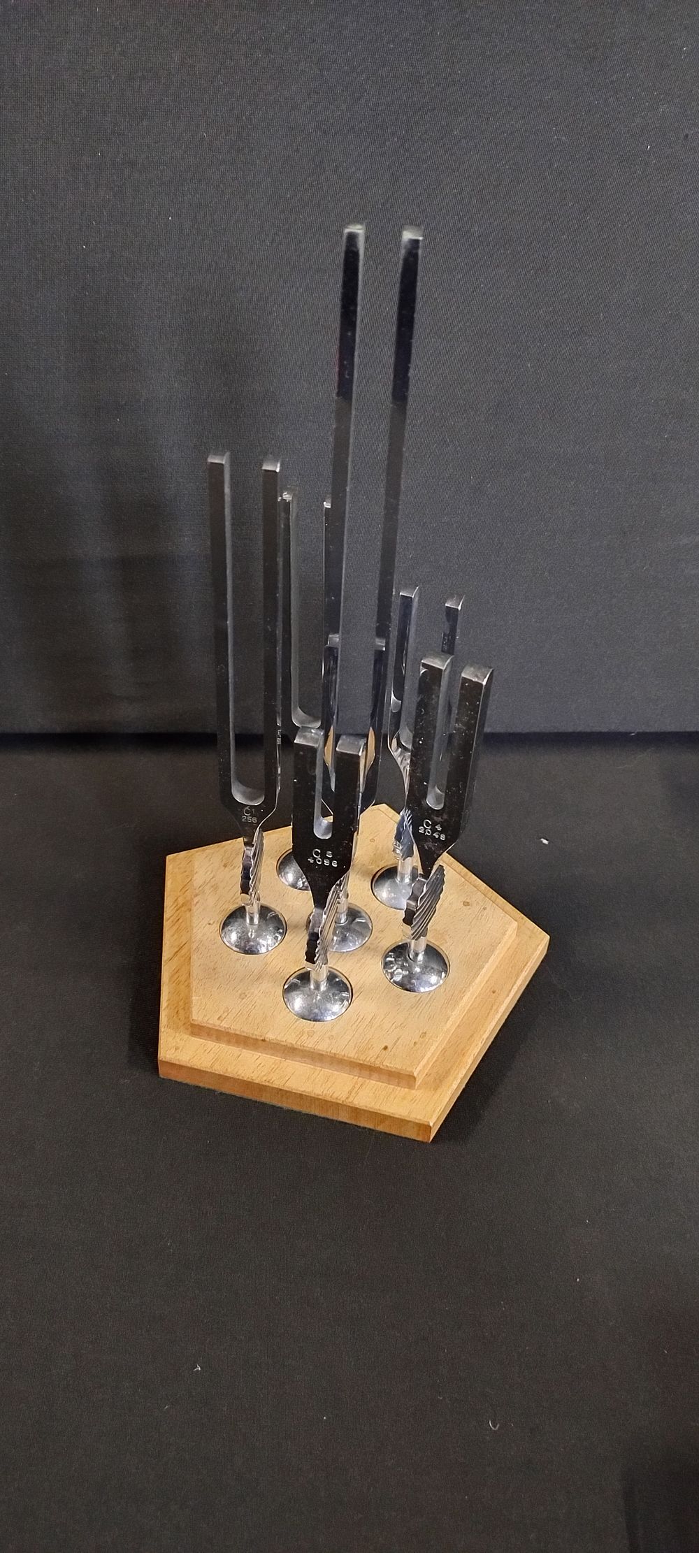 Lot 320: Full set of tuning forks on a wooden...