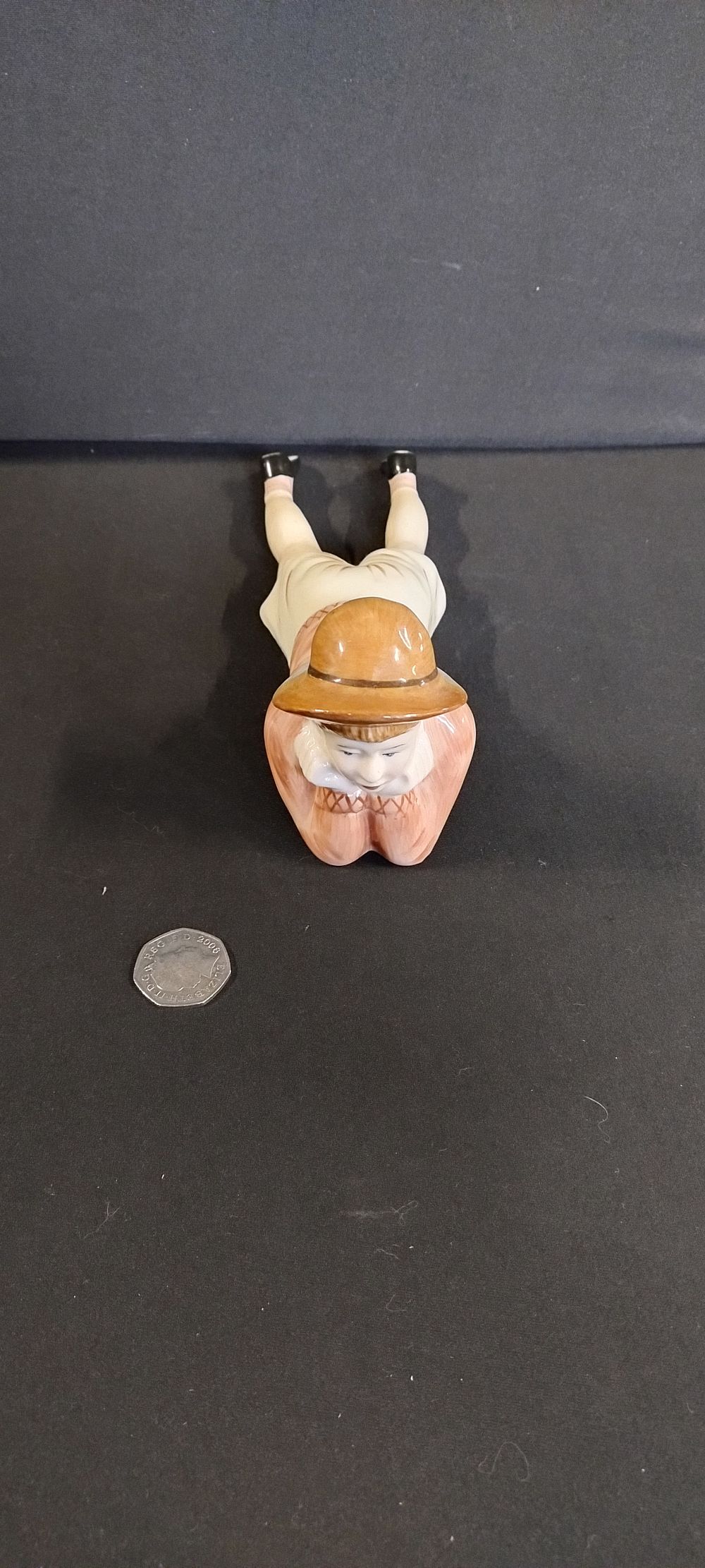 Lot 336: Porcelain figure of a boy lying down