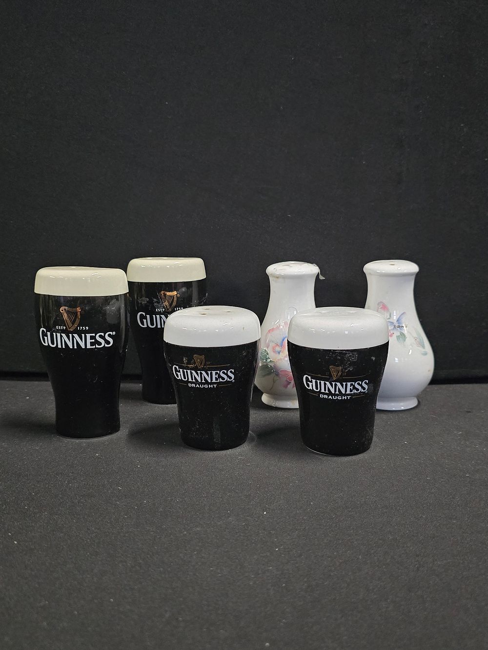 Lot 348: Two vintage GUINESS salt and pepper pots. With...