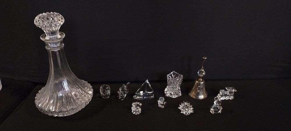 Lot 365: Selection of crystal animals, boat, train, bell with...