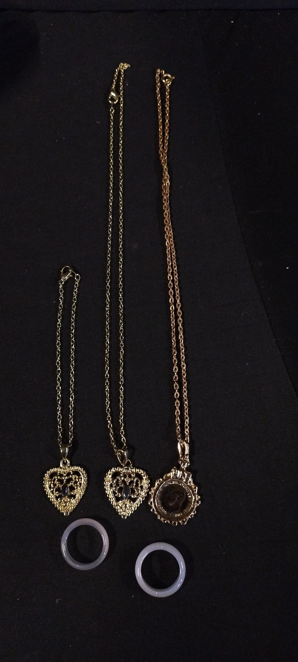 Lot 396: Gold plated coin on chain and a necklace,...