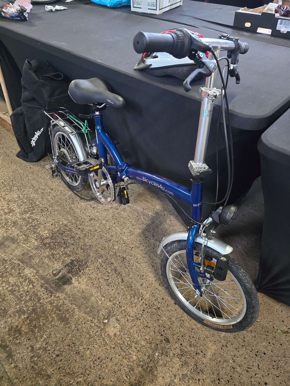 Lot 497: Like new blue folding bike with storage bag...
