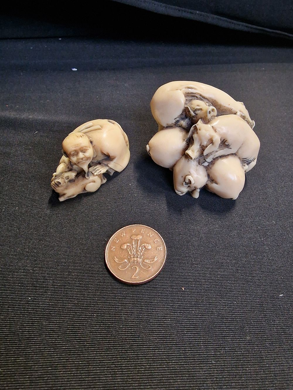 Lot 246: Pair of Resin Ornaments. Pile of Pigs and Man with Dog