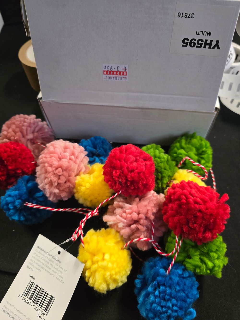 Lot 337: Two pompom string decorations