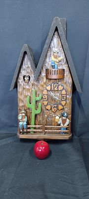 A unique battery operated cuckoo clock with cowboys and an owl. Measures approx H 65.5 x W 35.5 