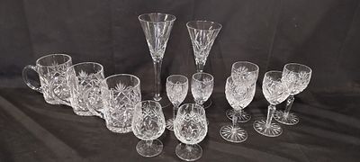 Collection of cut glass including pinwheel wine glasses, tankards and other glasses