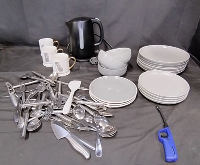 Various kitchen items including kettle, plates, dishes, and other items