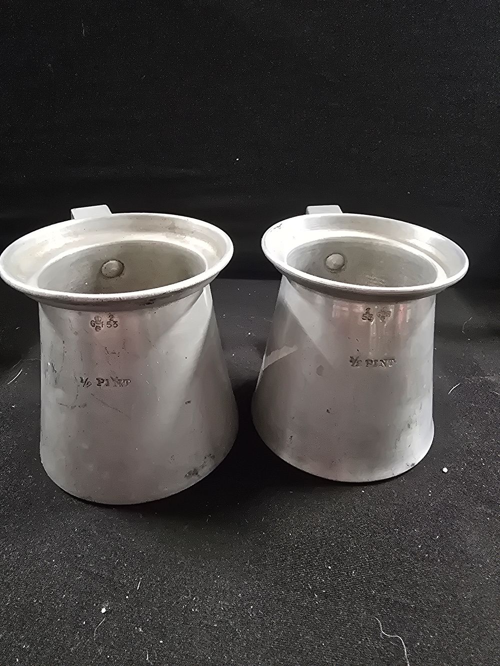Lot 369: A pair of half pint measuring jugs