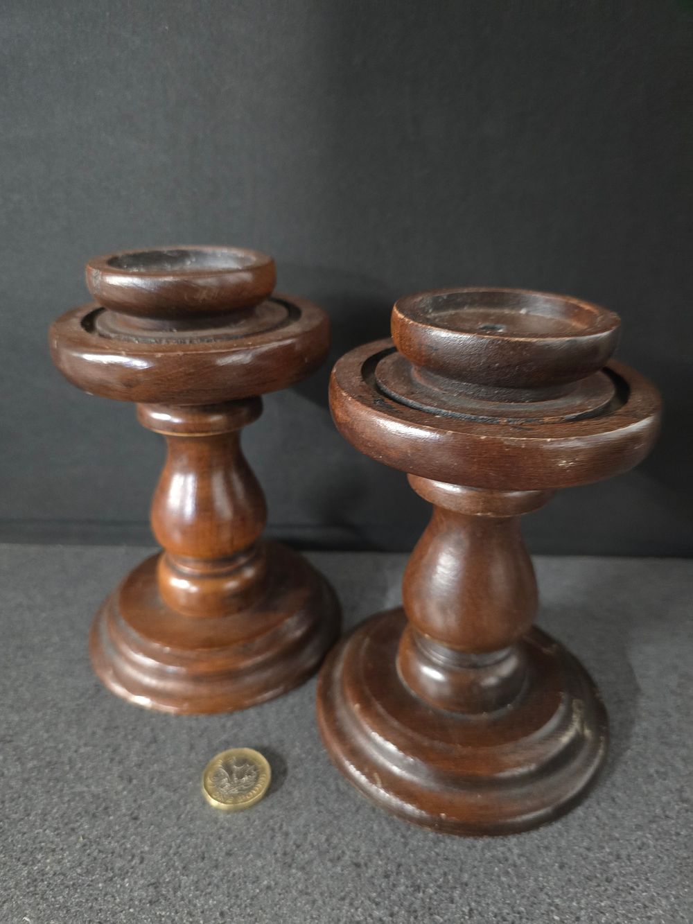 Lot 343: A pair of wooden candle sticks