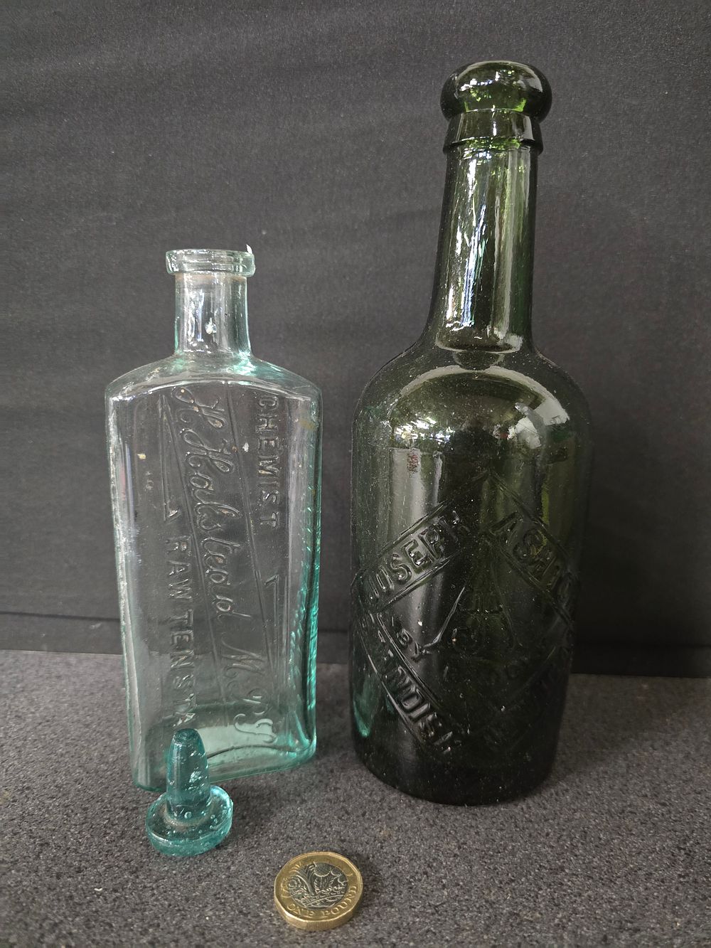 Lot 350: Two vintage glass embossed bottles one with stopper
