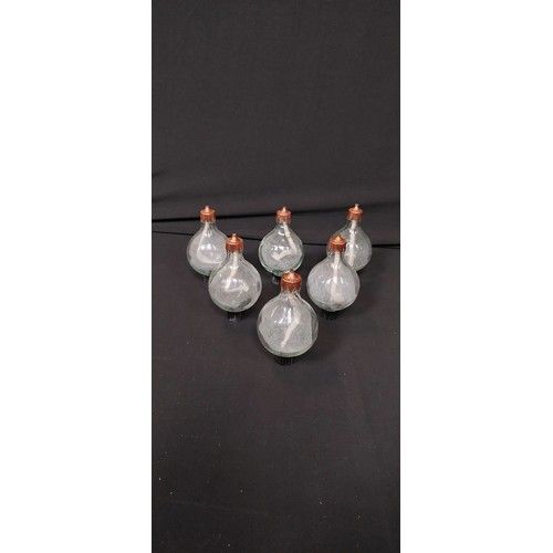 Lot 252: Set of 6 oil lamp candles with copper coloured tops