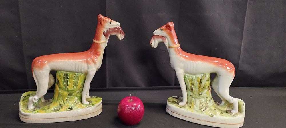Lot 161: Pair of whippets with rabbits. Possibly Staffordshire pottery
