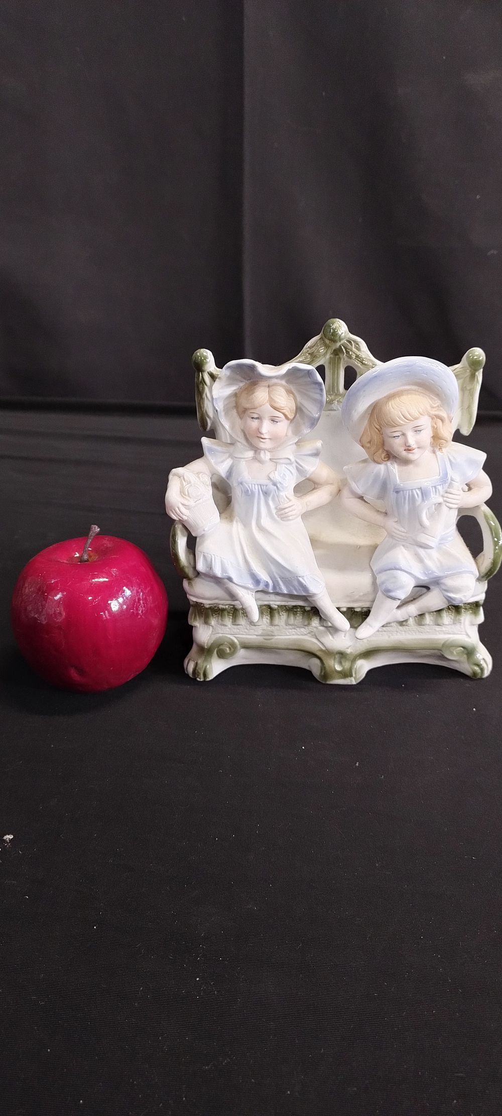 Lot 164: Porcelain ornament with girl and boy seated on...