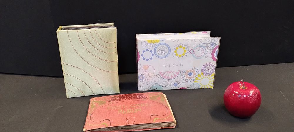 Lot 239: Three post card albums containing various vintage postcards...
