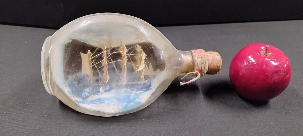 Lot 259: Miniature ship in a Dimple bottle