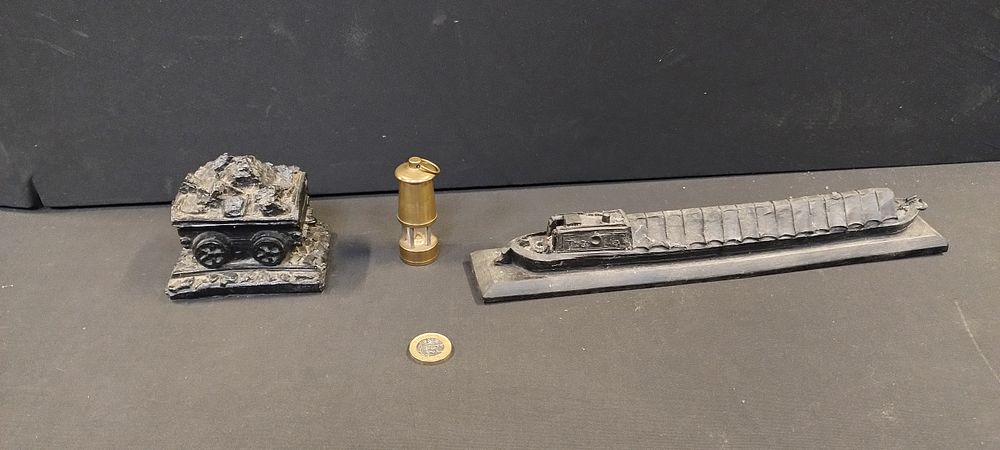 Lot 265: Two coal carvings, coal cart barge and a...