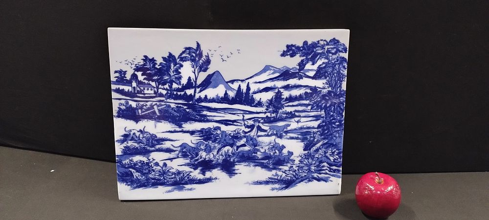 Lot 280: Large blue and white tile featuring a hunting...