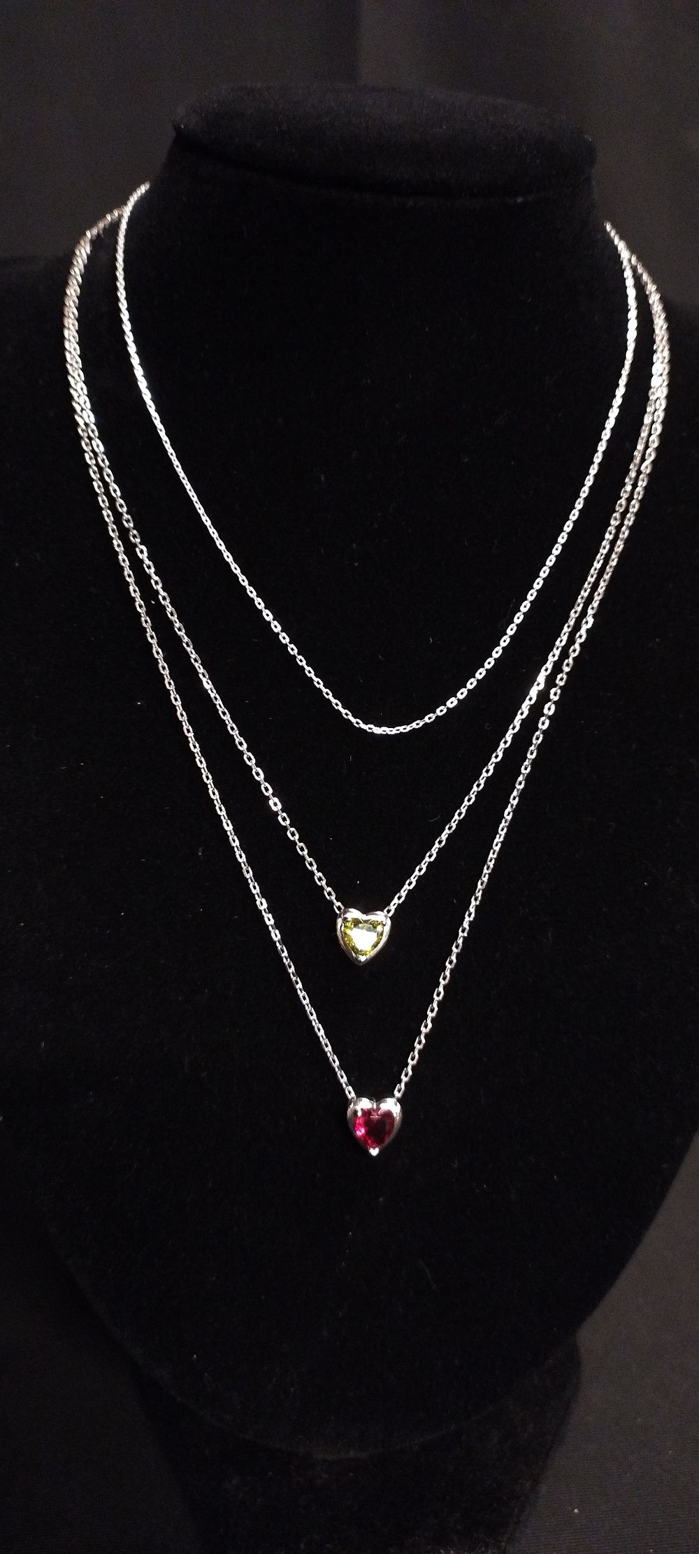 Lot 358: Three necklaces one plain, two with a heart...