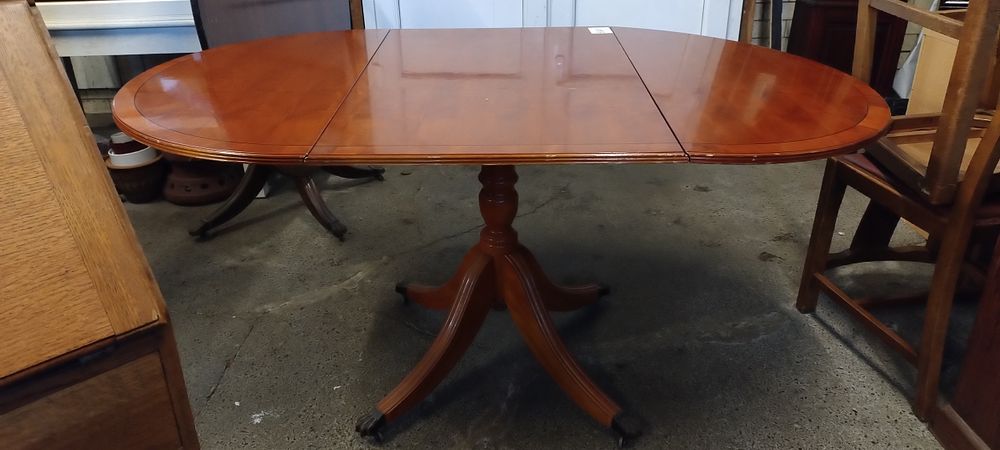 Lot 422: Drop leaf oval table with Lion claw feet...