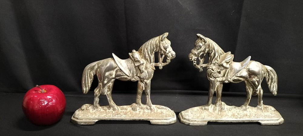 Lot 215: Pair of cast metal horse door stops. Measures...