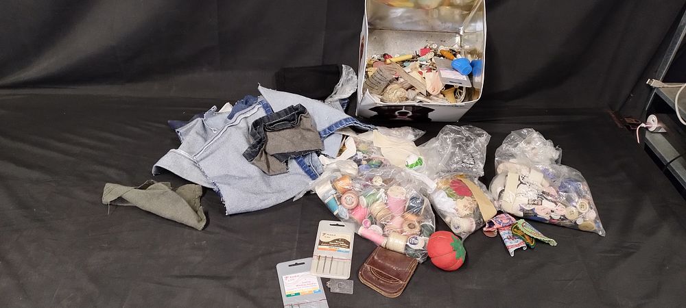 Lot 265: Tin containing various items including buttons sewing threads...