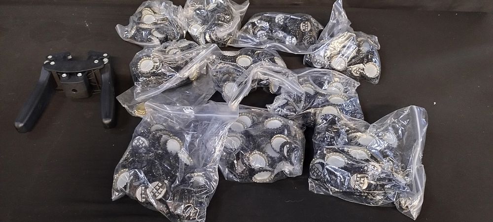 Lot 281: 10 bags of bottle caps and a bottle...