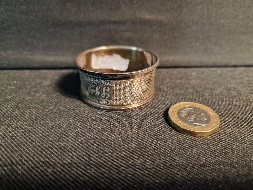 Lot 214: Sterling silver hallmarked napkin Ring.  Weight 12.70g approx.