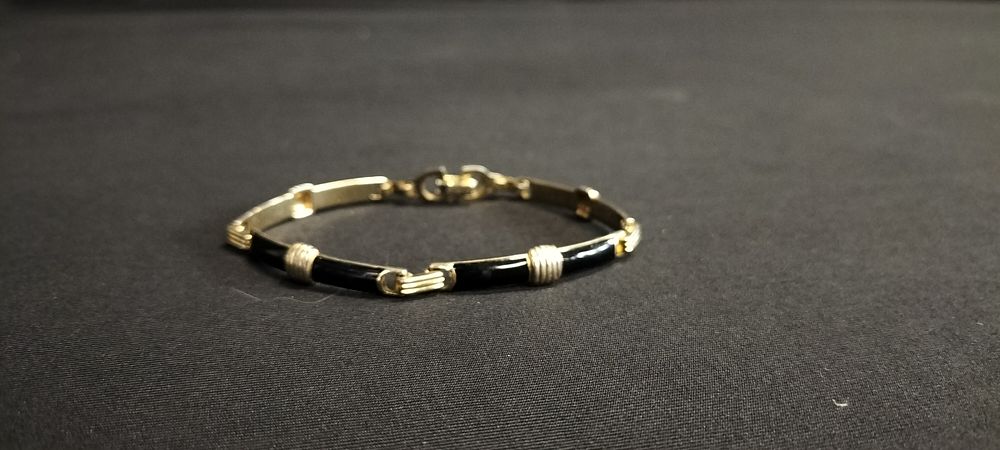 Lot 165: Christian Dior gold tone and black enamel bracelet