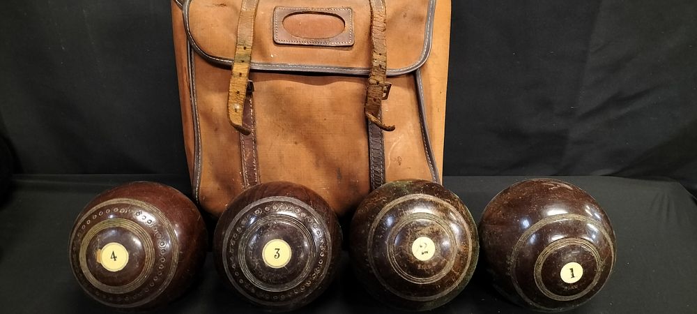 Lot 222: Set of 4 lawn bowls and satchel carry...