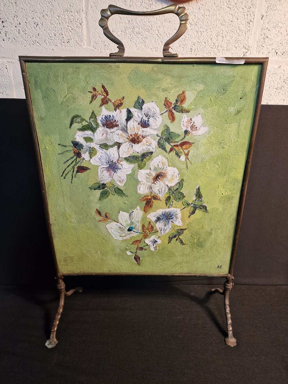 Lot 207: Vintage Brass fire screen with painted front panel. Measures approx H74 x W49 x D 20 cm