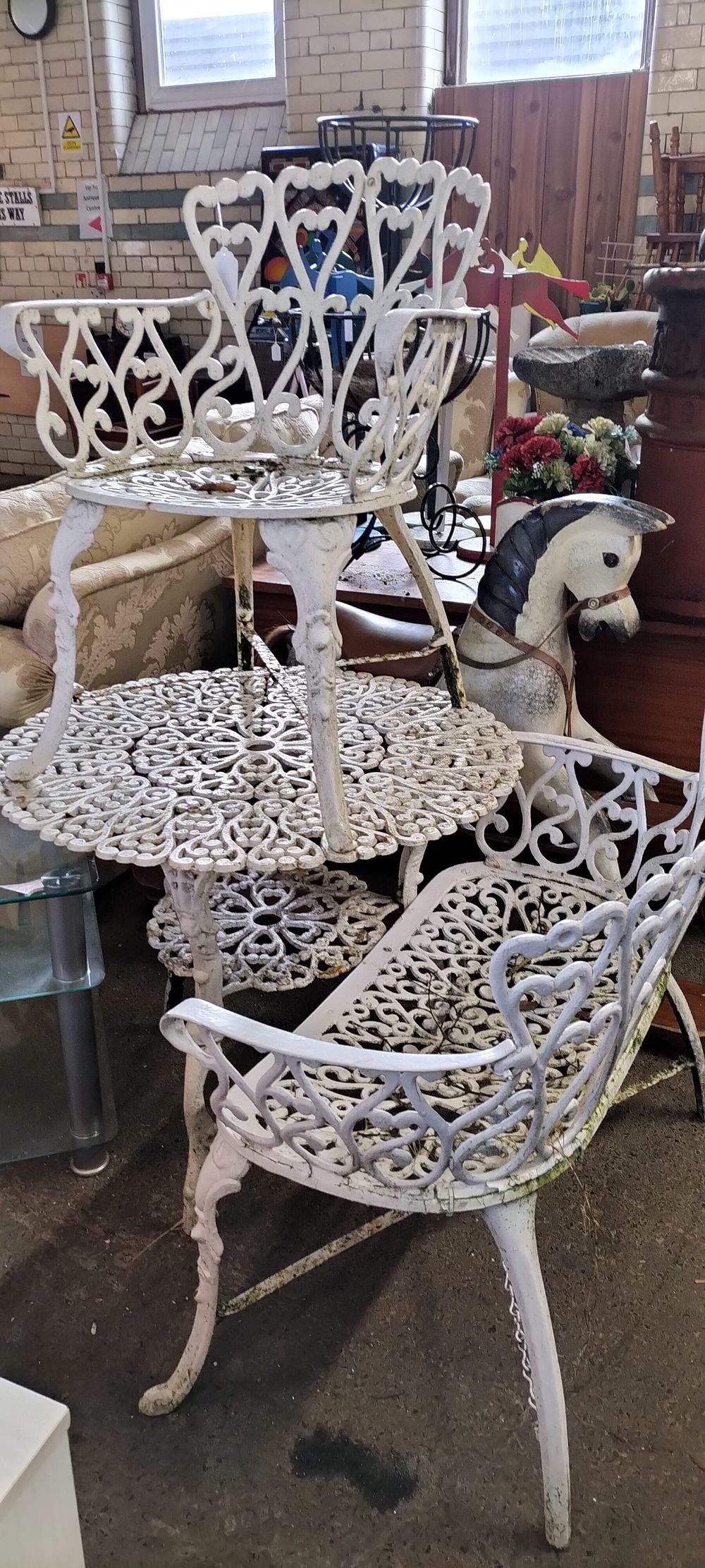 Lot 257: White cast iron garden set. Table bench seat...